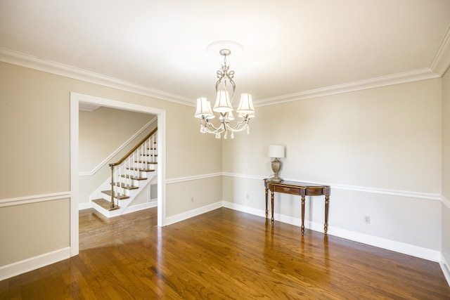 unfurnished room with a chandelier, crown molding, and dark hardwood / wood-style flooring