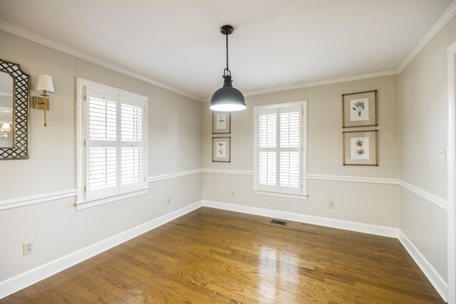 unfurnished dining area featuring crown molding and hardwood / wood-style floors