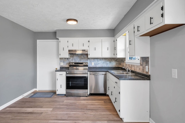 kitchen with sink, appliances with stainless steel finishes, a textured ceiling, white cabinets, and light wood-type flooring