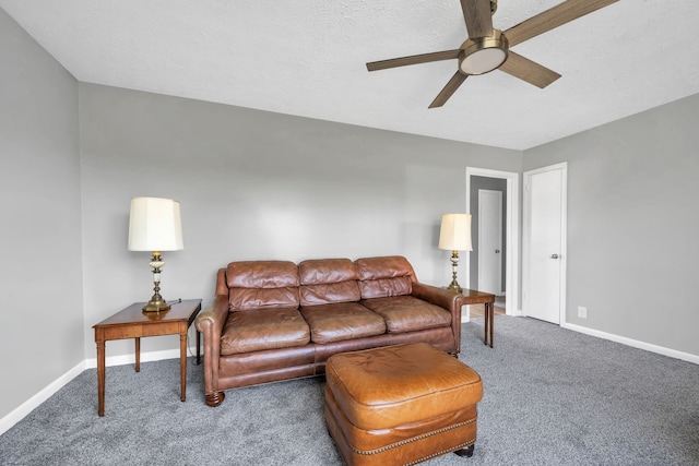 carpeted living room featuring a textured ceiling and ceiling fan