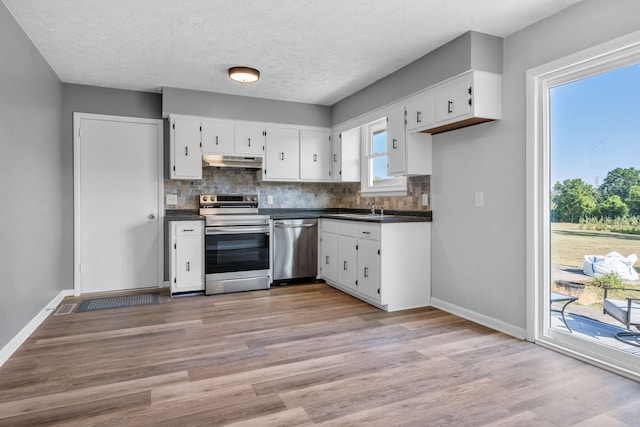 kitchen featuring white cabinetry, sink, stainless steel appliances, light hardwood / wood-style flooring, and a textured ceiling