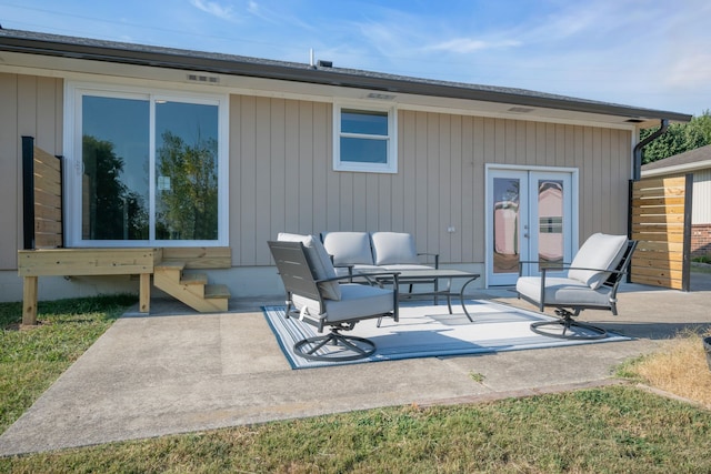 back of property with a patio area and french doors