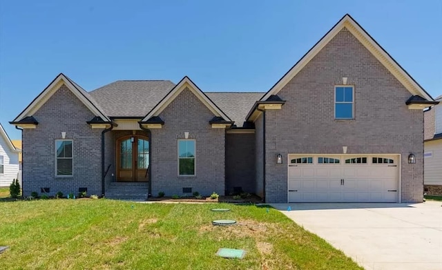 view of front of house featuring a front yard, french doors, and a garage