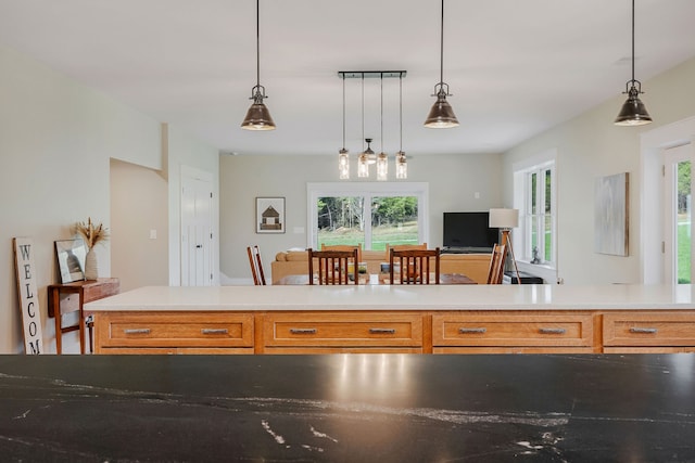 kitchen with plenty of natural light and decorative light fixtures