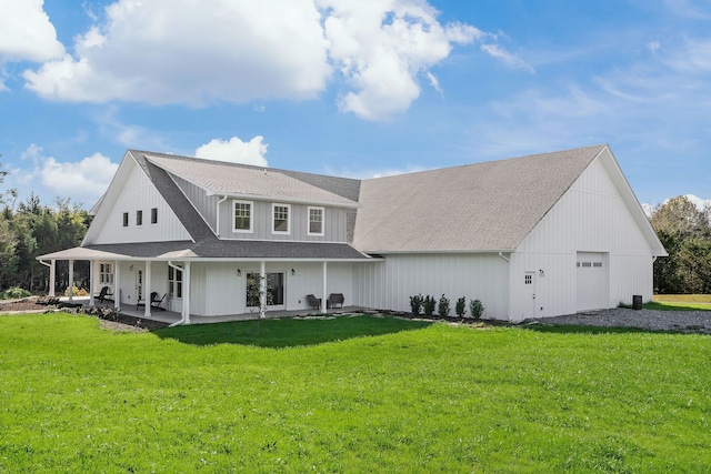 rear view of house with a lawn and a garage