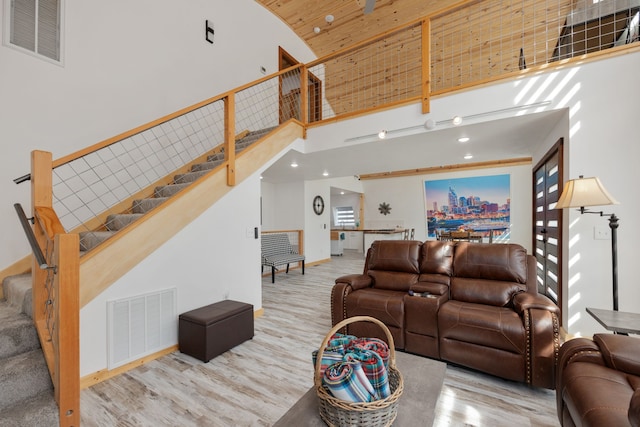 living room featuring wood-type flooring and a high ceiling