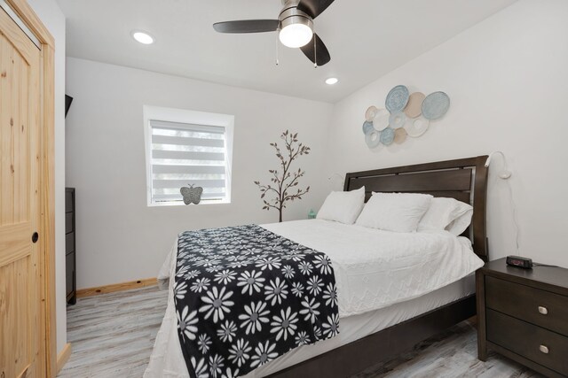 bedroom with ceiling fan and light hardwood / wood-style flooring