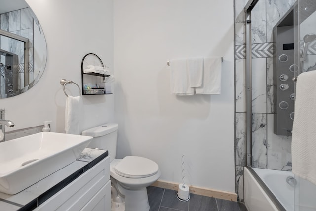 full bathroom featuring tile patterned floors, vanity, toilet, and bath / shower combo with glass door