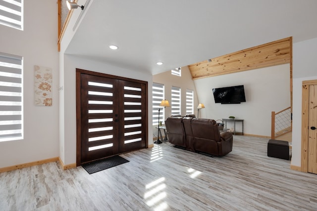 entryway with french doors and light hardwood / wood-style floors