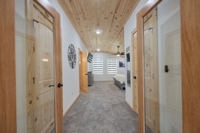 corridor featuring light carpet, wood ceiling, and lofted ceiling