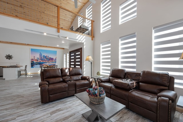 living room with high vaulted ceiling, wood ceiling, and hardwood / wood-style flooring