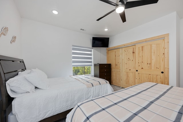 bedroom with ceiling fan, a closet, and hardwood / wood-style flooring