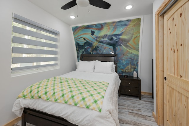 bedroom featuring ceiling fan and light hardwood / wood-style floors