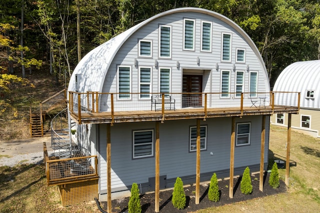 rear view of house featuring a wooden deck