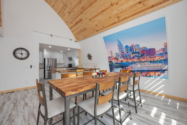 dining space with wooden ceiling, lofted ceiling, and light hardwood / wood-style floors