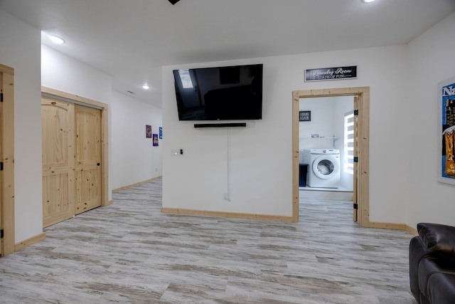 living room featuring washer / clothes dryer and light hardwood / wood-style floors