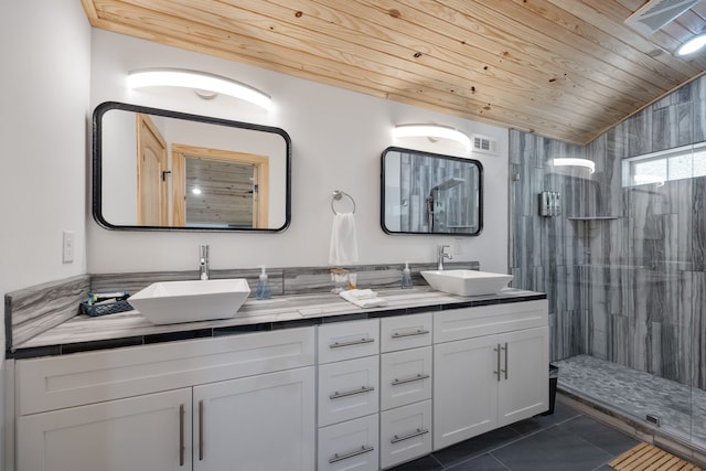 bathroom featuring vanity, wooden ceiling, lofted ceiling, tile patterned flooring, and tiled shower