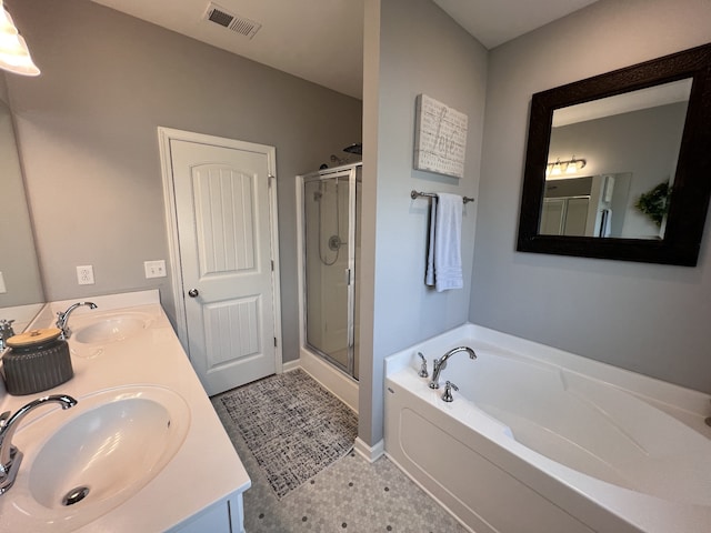 bathroom with independent shower and bath, vanity, and tile patterned floors