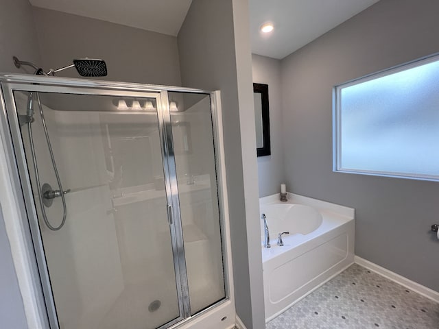 bathroom featuring shower with separate bathtub