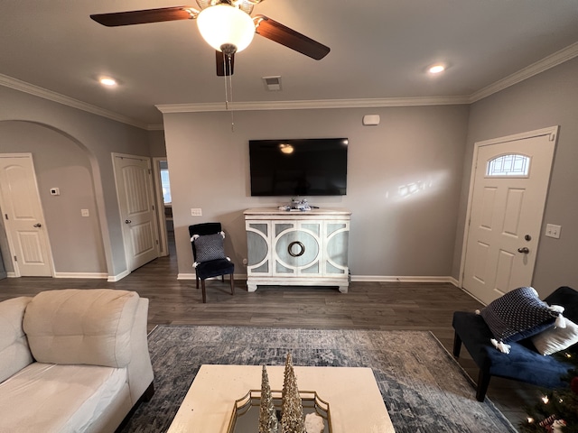 living room featuring ceiling fan, ornamental molding, and dark hardwood / wood-style flooring