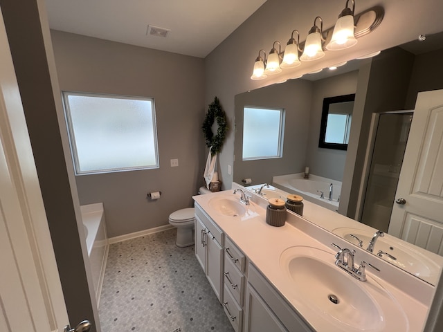 full bathroom featuring independent shower and bath, vanity, and toilet