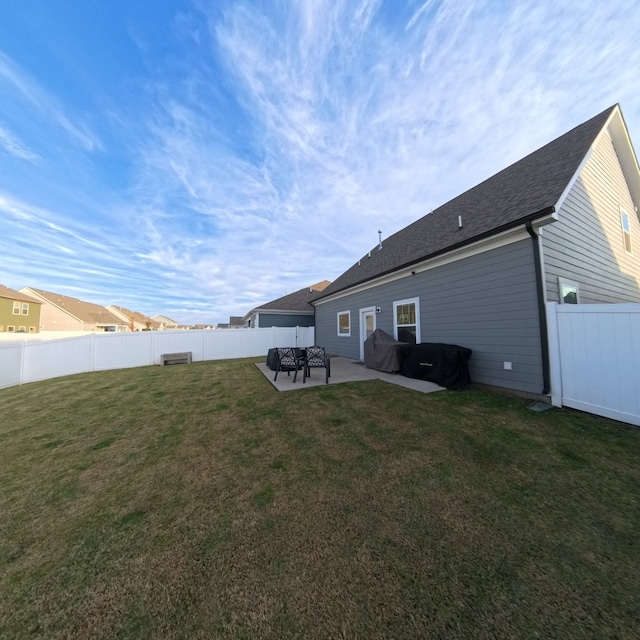 rear view of property with a lawn and a patio area