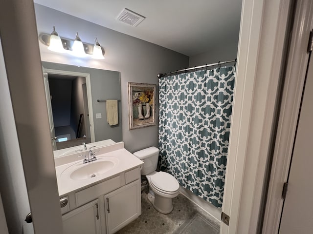 bathroom featuring vanity and toilet