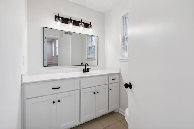 bathroom featuring tile patterned flooring and vanity