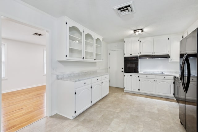 kitchen featuring oven, stainless steel fridge, light hardwood / wood-style floors, cooktop, and white cabinetry