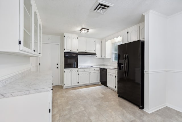 kitchen featuring black appliances, sink, white cabinets, and a textured ceiling