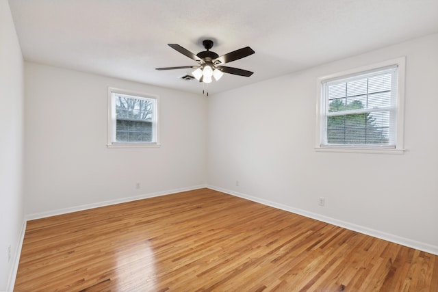 unfurnished room featuring ceiling fan, a healthy amount of sunlight, and light wood-type flooring