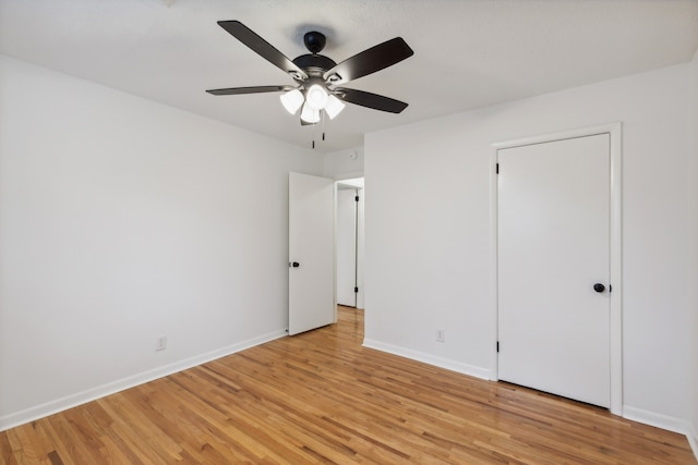 unfurnished bedroom with ceiling fan and light wood-type flooring