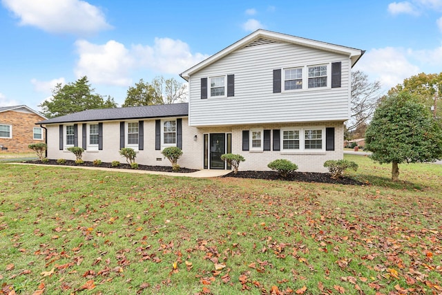 split level home featuring a front lawn