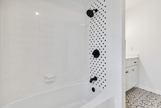 bathroom featuring vanity and tiled shower / bath