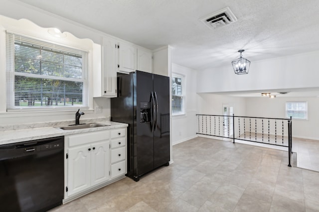 kitchen with white cabinetry, sink, an inviting chandelier, decorative light fixtures, and black appliances