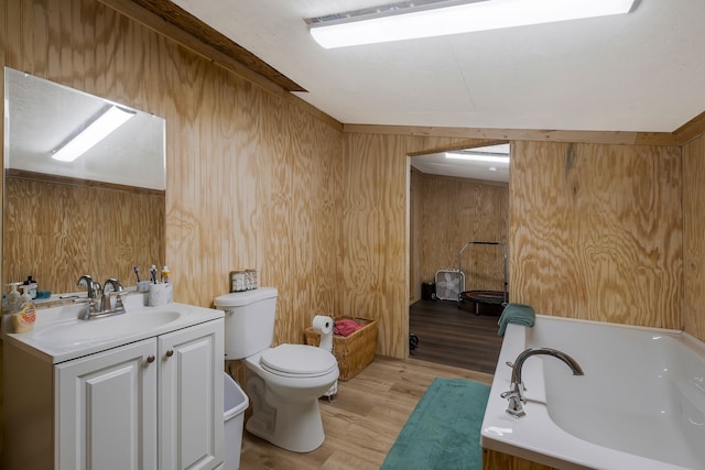 bathroom featuring vanity, hardwood / wood-style flooring, toilet, and wooden walls