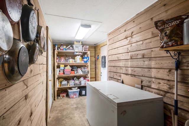 laundry area with wooden walls