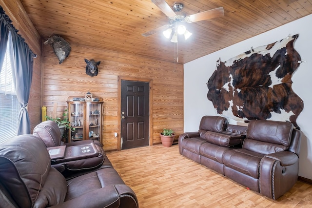 living room with wooden walls, light hardwood / wood-style flooring, ceiling fan, and wood ceiling