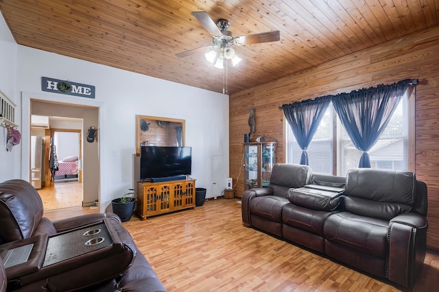 living room featuring wood walls, ceiling fan, wood ceiling, and light wood-type flooring