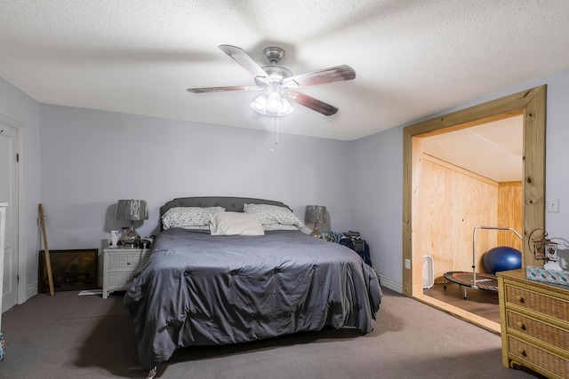 bedroom with carpet, ceiling fan, and a textured ceiling