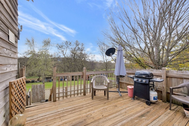 wooden deck featuring a grill