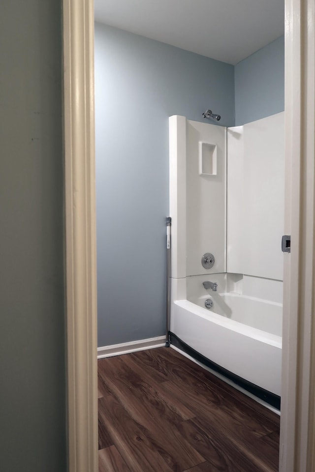 bathroom with hardwood / wood-style flooring and shower / bath combination