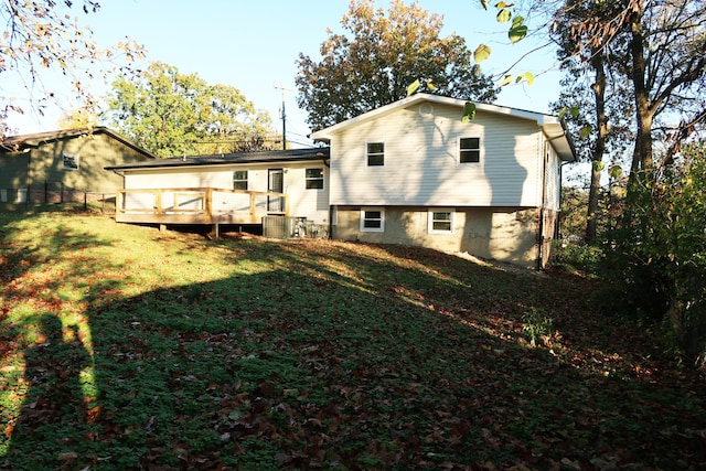 rear view of house with a lawn and a deck