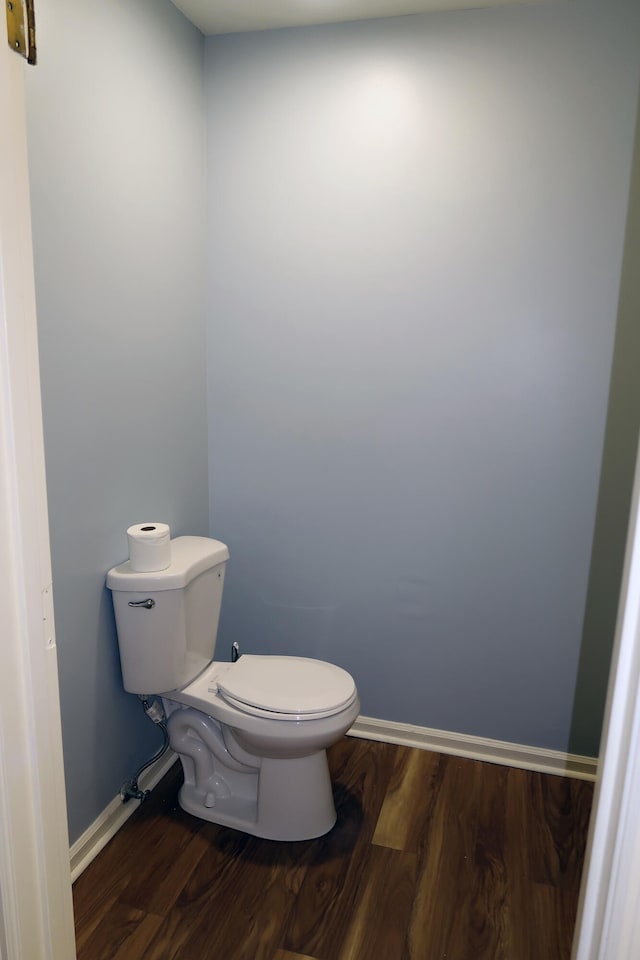 bathroom with toilet and hardwood / wood-style flooring