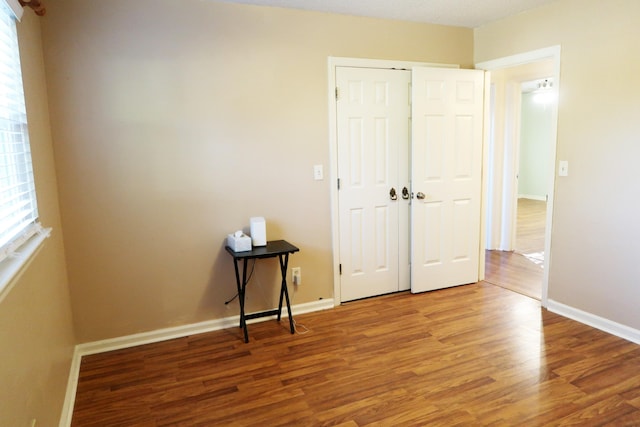 unfurnished bedroom featuring wood-type flooring and a closet