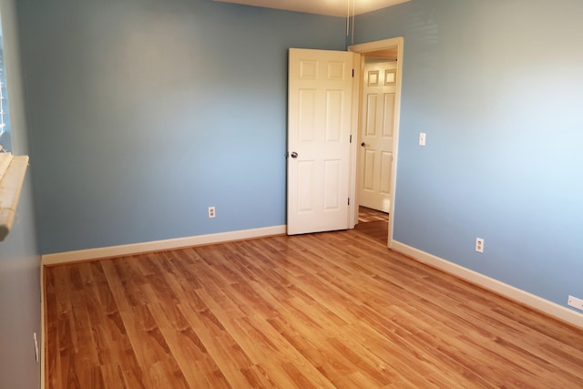 spare room featuring light hardwood / wood-style floors