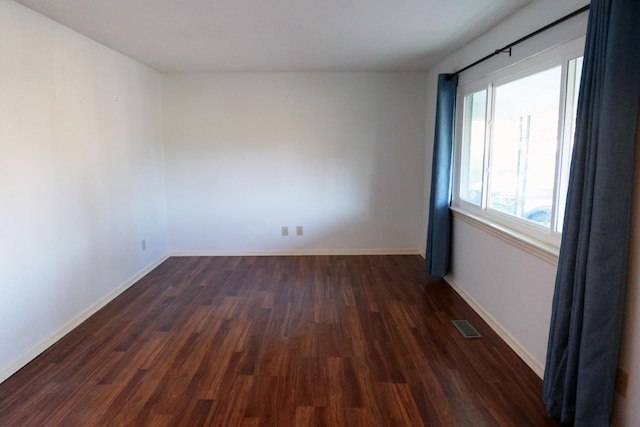 unfurnished room featuring dark hardwood / wood-style flooring