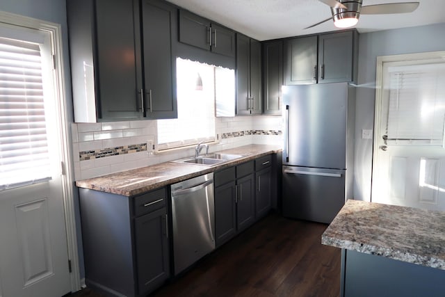 kitchen with gray cabinetry, sink, dark hardwood / wood-style flooring, and appliances with stainless steel finishes