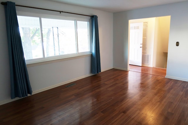 spare room featuring dark wood-type flooring