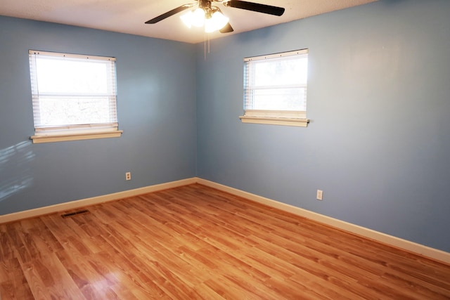 spare room with ceiling fan, light hardwood / wood-style floors, and a textured ceiling